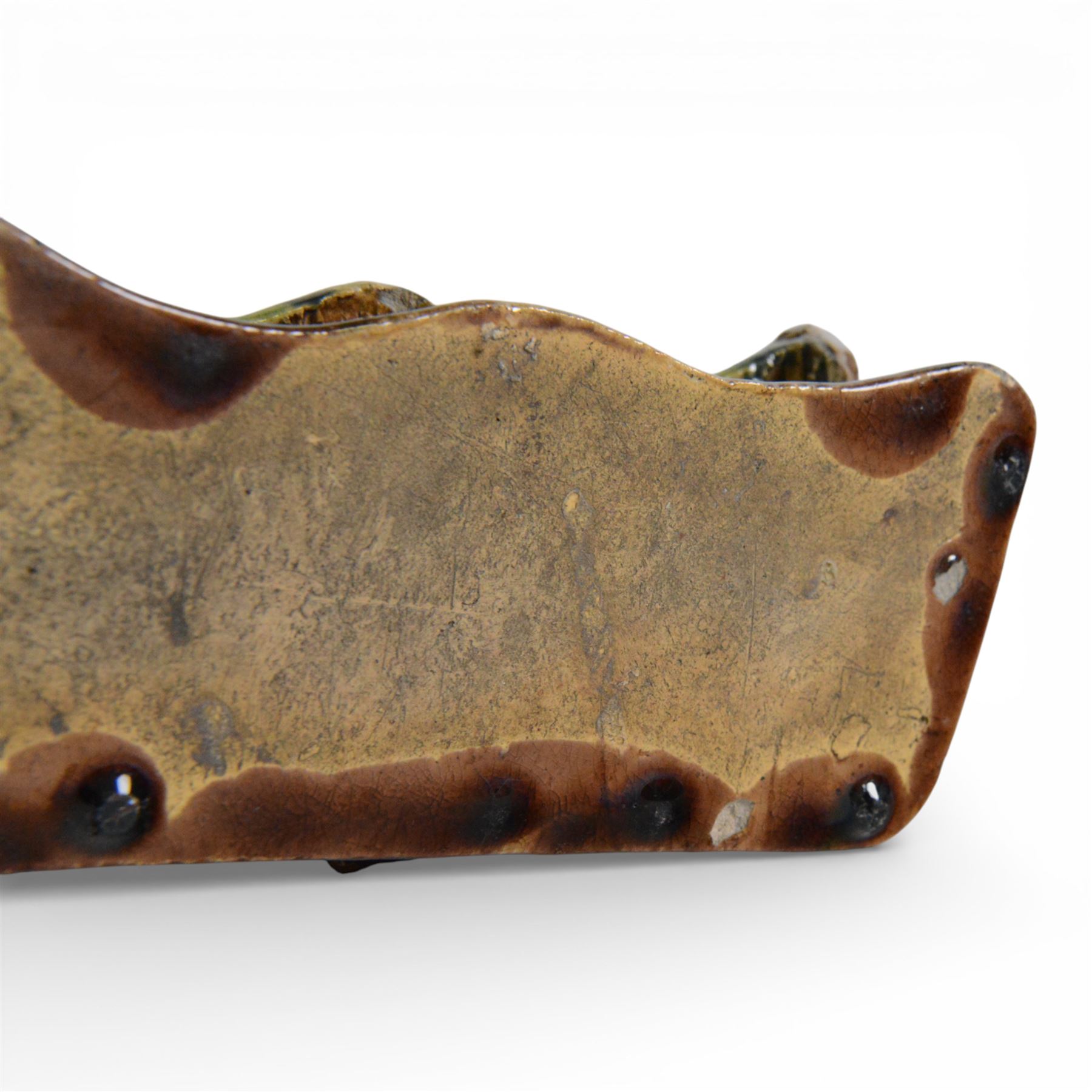 19th century pottery model of a bench, possibly Skey Pottery Tamworth, Staffordshire, the shaped seat mottled in shades of green, dark blue, yellow and brown, supported upon naturalistically modelled tree stumps, the arms and back modelled as intertwined branches, H14cm W21cm D10cm