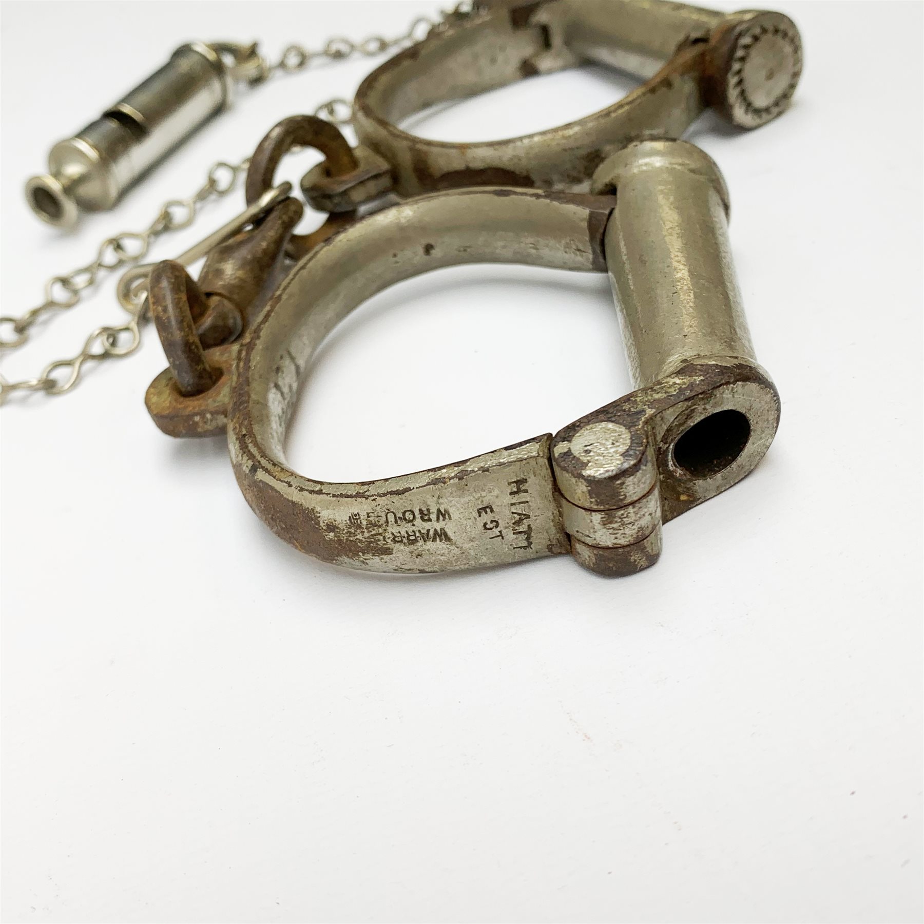 Pair of 1920's Hiatt nickel plated handcuffs marked 'Warranted Wrought' with screw-in key and a 'Metropolitan' whistle