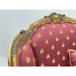 Victorian carved giltwood armchair, the shaped cresting rail decorated with shell cartouche and flower head motifs, down swept arms with acanthus leaf and scrolled terminals, upholstered in red ground fabric decorated with repeating gilt motif pattern, shell carved supports