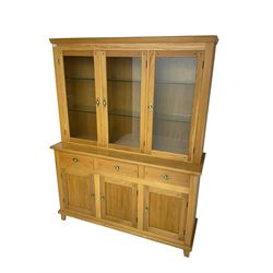 Light oak dresser, three glazed doors enclosing six adjustable glass shelves, with internal light fittings to top, above three drawers and three cupboards