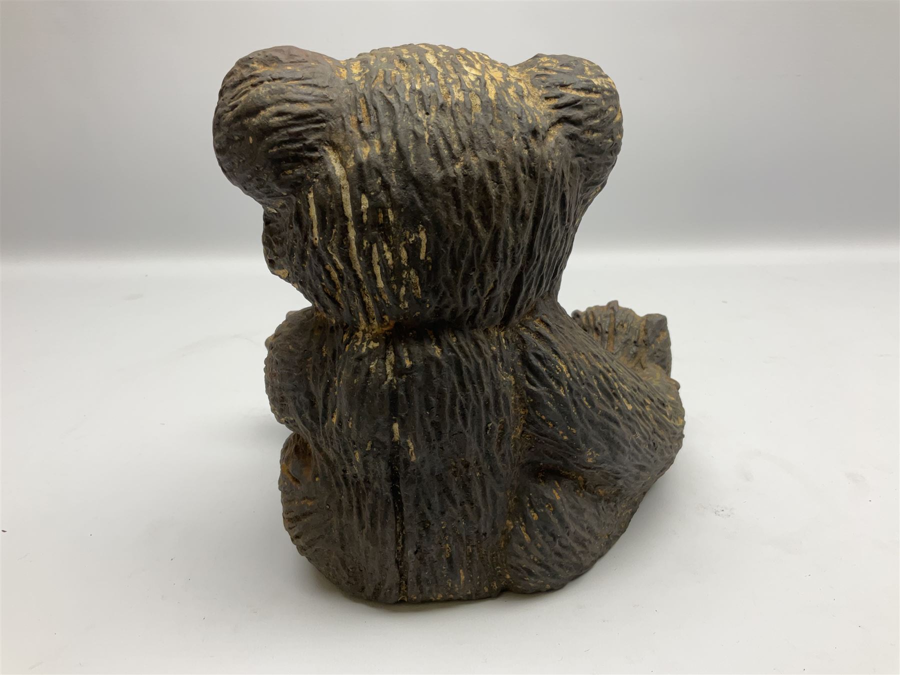 19th century cast iron door stop, modelled as a seated toy bear, with remnants of painted finish, H22.5cm