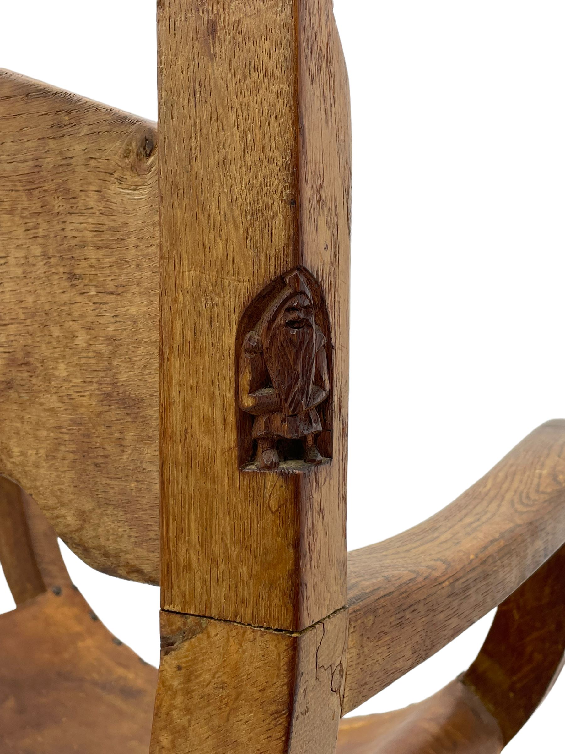 'Gnomeman' oak curved x-framed throne chair, sloped arched cresting rail carved with arcade, studded slung leather seat, the supports joined by sledge feet, rear upright carved with gnome signature, by Thomas Whittaker of Littlebeck
