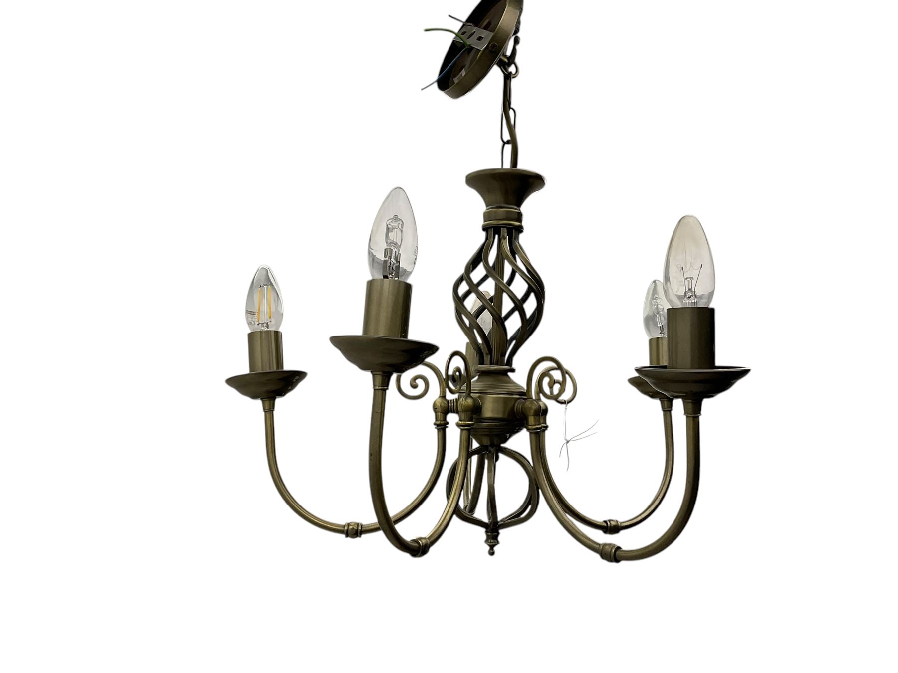 Pair of brass five-branch chandeliers, each featuring scrolling arms with candle-style light fittings, centred by a twisted openwork column, complete with ceiling roses and hanging chains