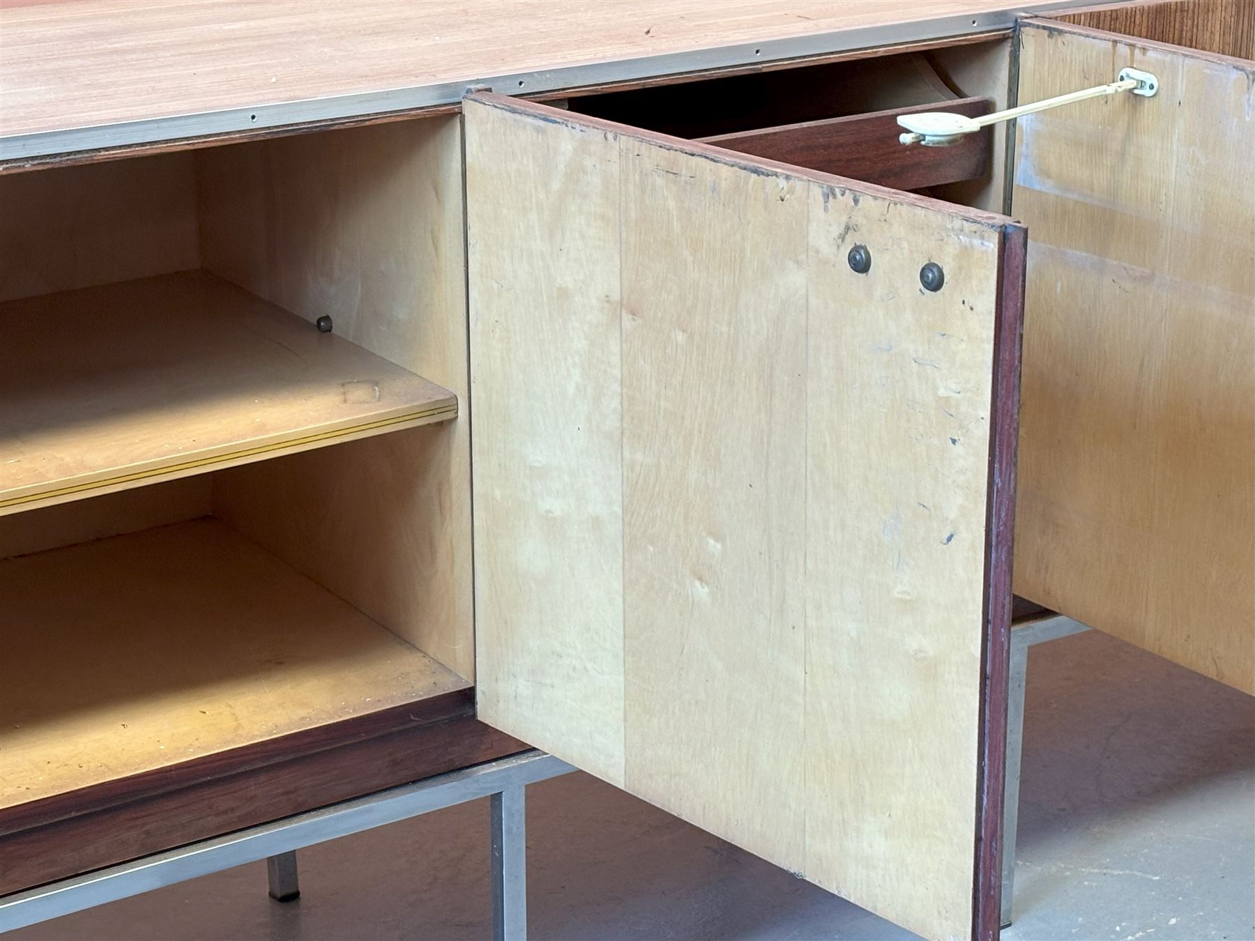 Large Italian teak veneered sideboard, circa 1960's, fitted with five drawers enclosing a birds eye maple lined interior fitted with shelves, raised on a chrome plated box section base. Water damage to doors and sides. H80cm, L245cm, D48cm  - COLLECTION BY APPOINTMENT FROM: The White House, Thirsk Road, Easingwold, York, YO61 3NF - CALL 01723 507111 TO ARRANGE