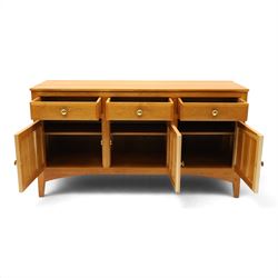 Traditional cherrywood sideboard, rectangular top above three fielded panelled drawers, three cupboard doors with triple panelled doors, brass knobs and hinges, tapered supports