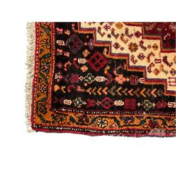 Small Hamadan dark indigo ground rug, central ivory and maroon lozenge with geometric decoration, guarded border with repeating stylised plant motifs, together with three others (4)