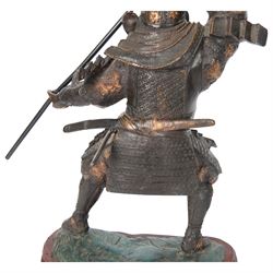 Japanese bronze of a Samurai, possibly Meiji period, standing holding a three pronged spear, on a wave form base, H67cm