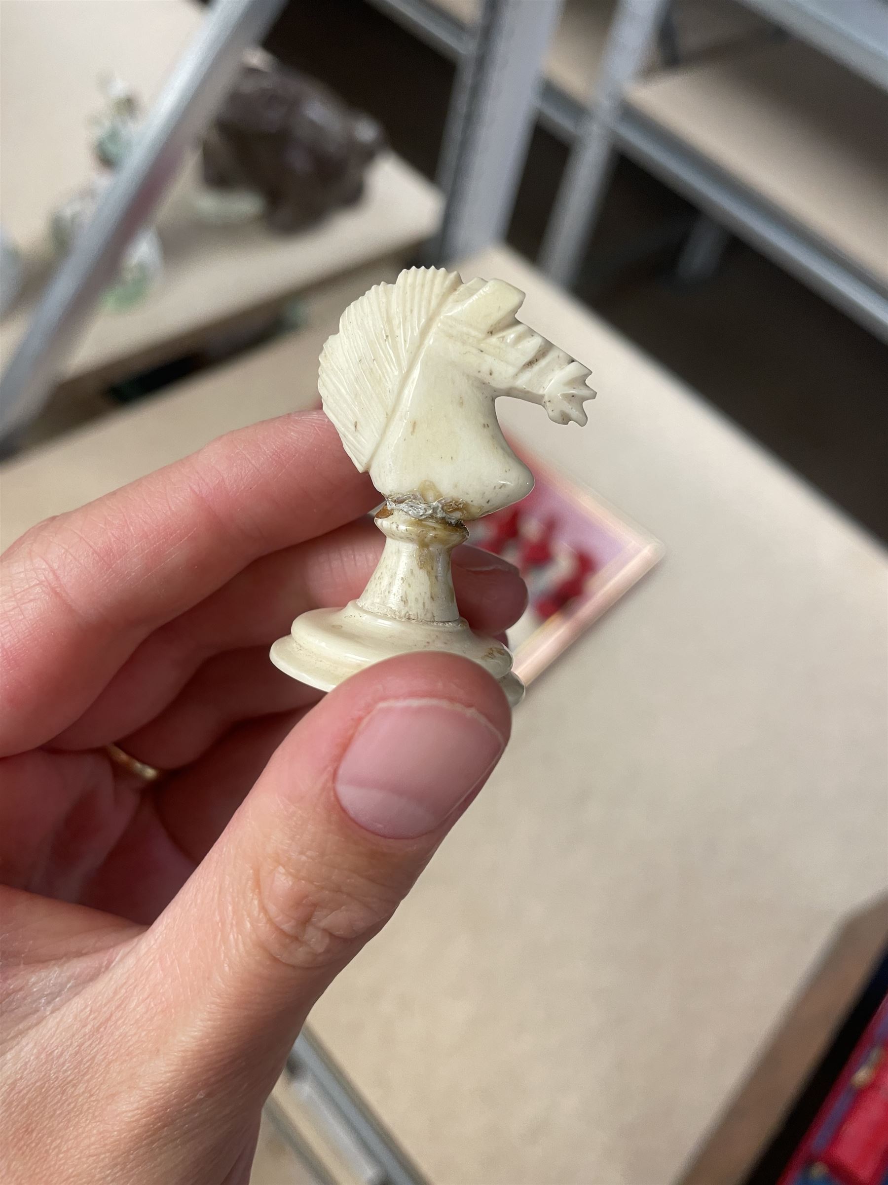 19th century walnut and brass bound games compendium box, painted to enhance the grain, of rectangular form, the hinged opening cover with rounded sides, central brass cartouche with engraved lion crest, and brass riveted straps, opening to reveal a red leather and blue silk lined compartmented interior, with fold-down games board, and lift-out tray containing playing cards, ebony turned dice towers, white and red stained bone draughts, and chess pieces, ivory dice, and ivory and ebony whist markers, and brass bezique board, cribbage board and markers, H15cm W32cm D24cm
This lot has been registered for sale under Section 10 of the APHA Ivory Act