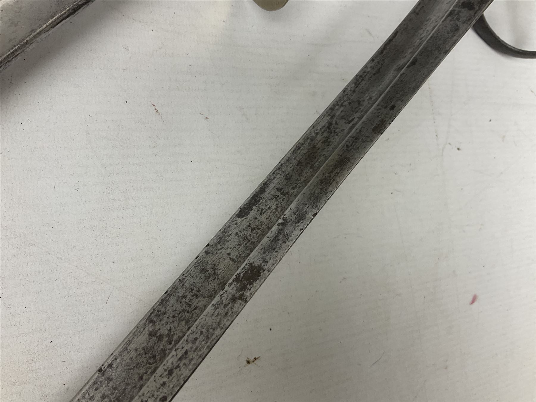 George V British Army 1897 pattern officers sword with plain 82cm fullered steel blade, pierced  basket hilt with George V cypher and wire bound leather grip with chequered backstrap; in leather covered field service scabbard L101cm overall; and another officer's sword in relic condition lacking scabbard (2)