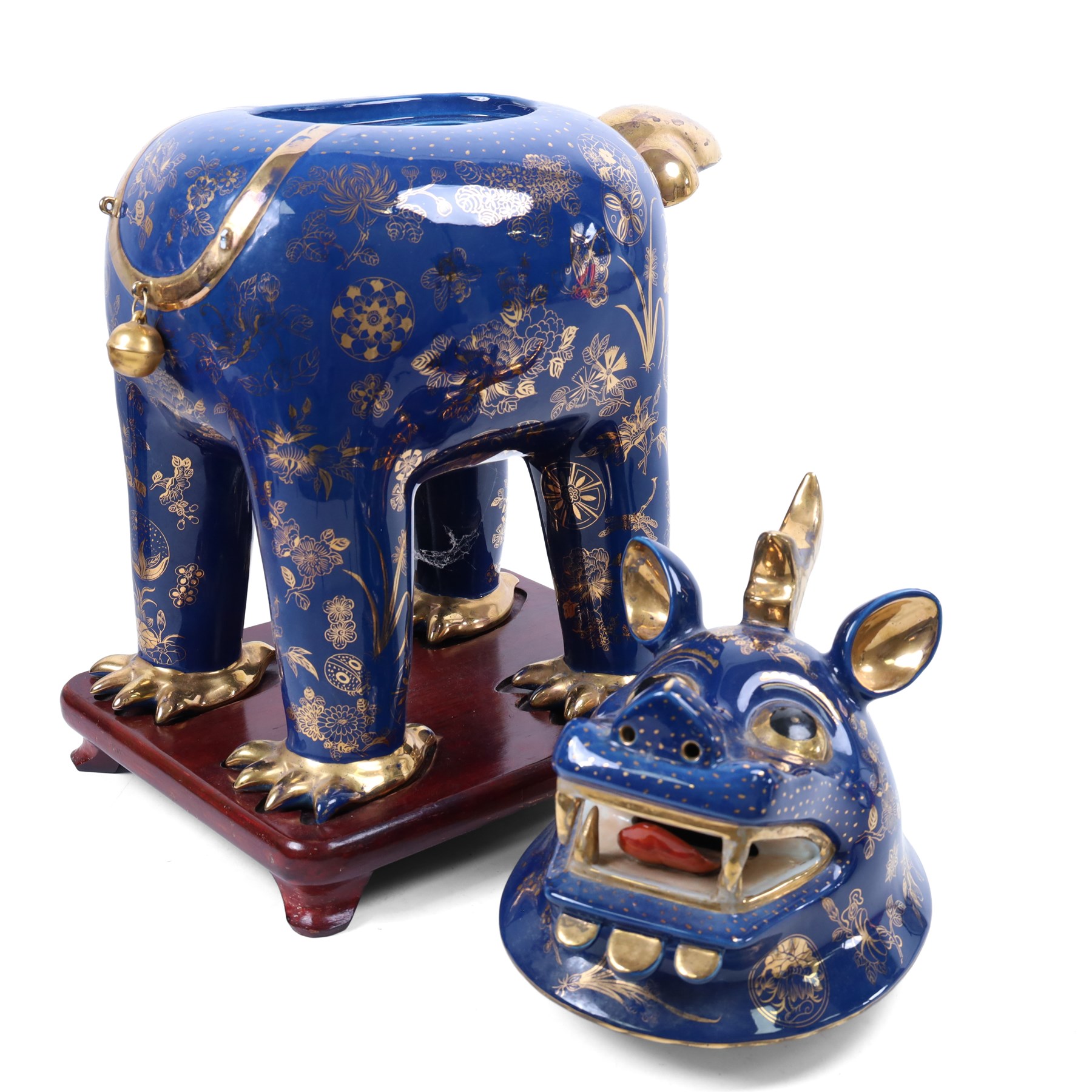 Pair of 20th century foo dog incense burners, decorated with gilt flowers and insects upon a blue ground, on wooden stands, H58cm 