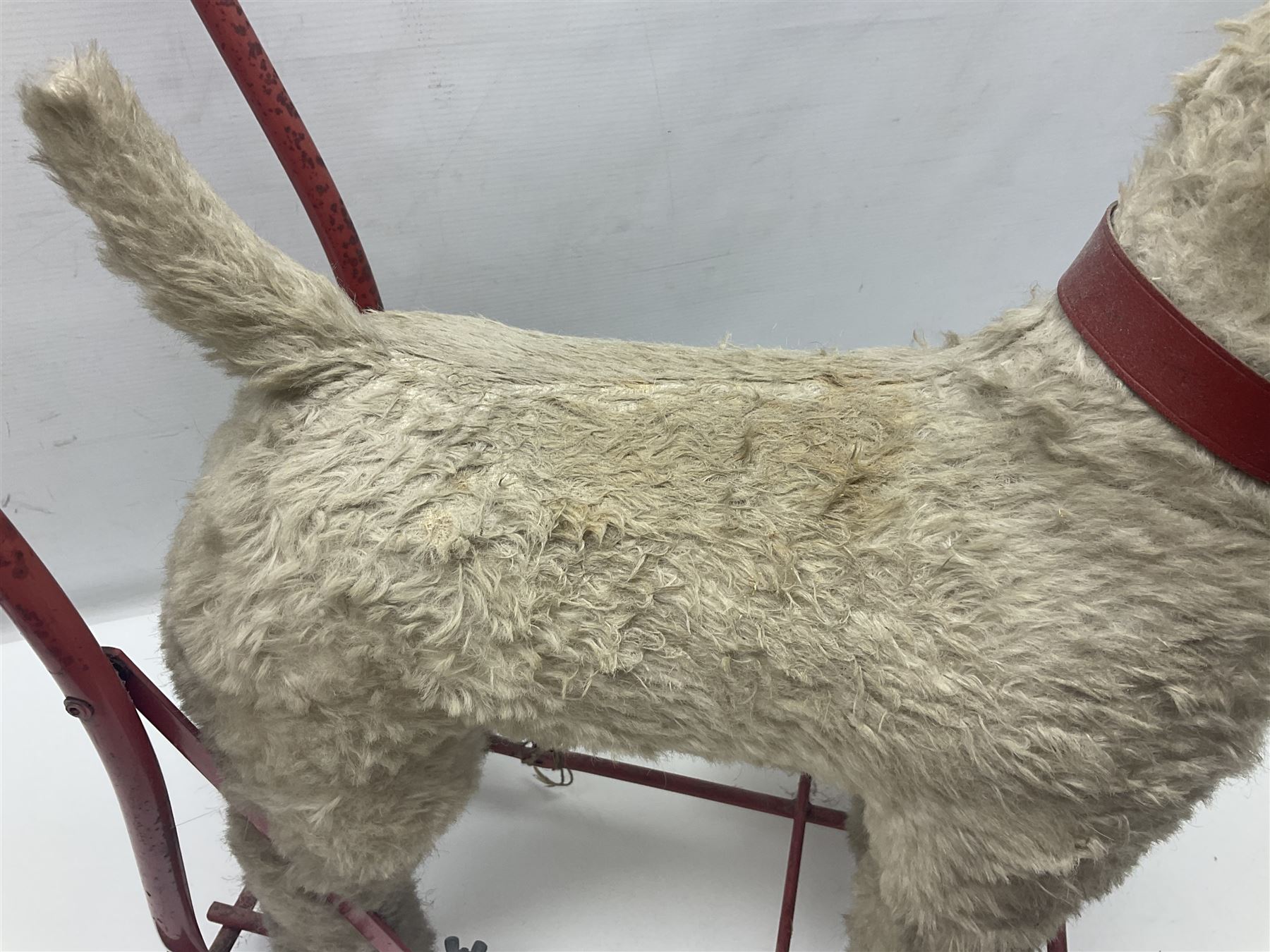 Tri ang - Pedigree Soft Toys - push along/ride-on dog as a wood wool filled plush Airedale terrier in red tubular frame with beech footrests and black rubber wheels; stitched Northern Ireland label in tact L60cm H61cm