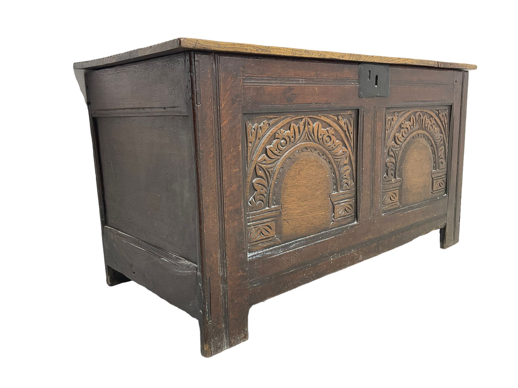 Jacobean Revival - 19th century oak blanket chest, rectangular hinged top, the two front panels carved arched foliate decoration, raised on stile supports