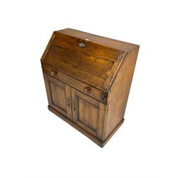 19th century waxed pine bureau, the fall front opening to reveal fitted interior with two drawers and five pigeonholes, base with single drawer over two panelled cupboard doors, on plinth base