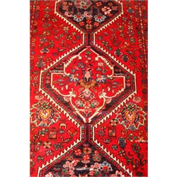  Bokhara red ground rug, repeating elephant foot medallions, 240cm x 188cm  
