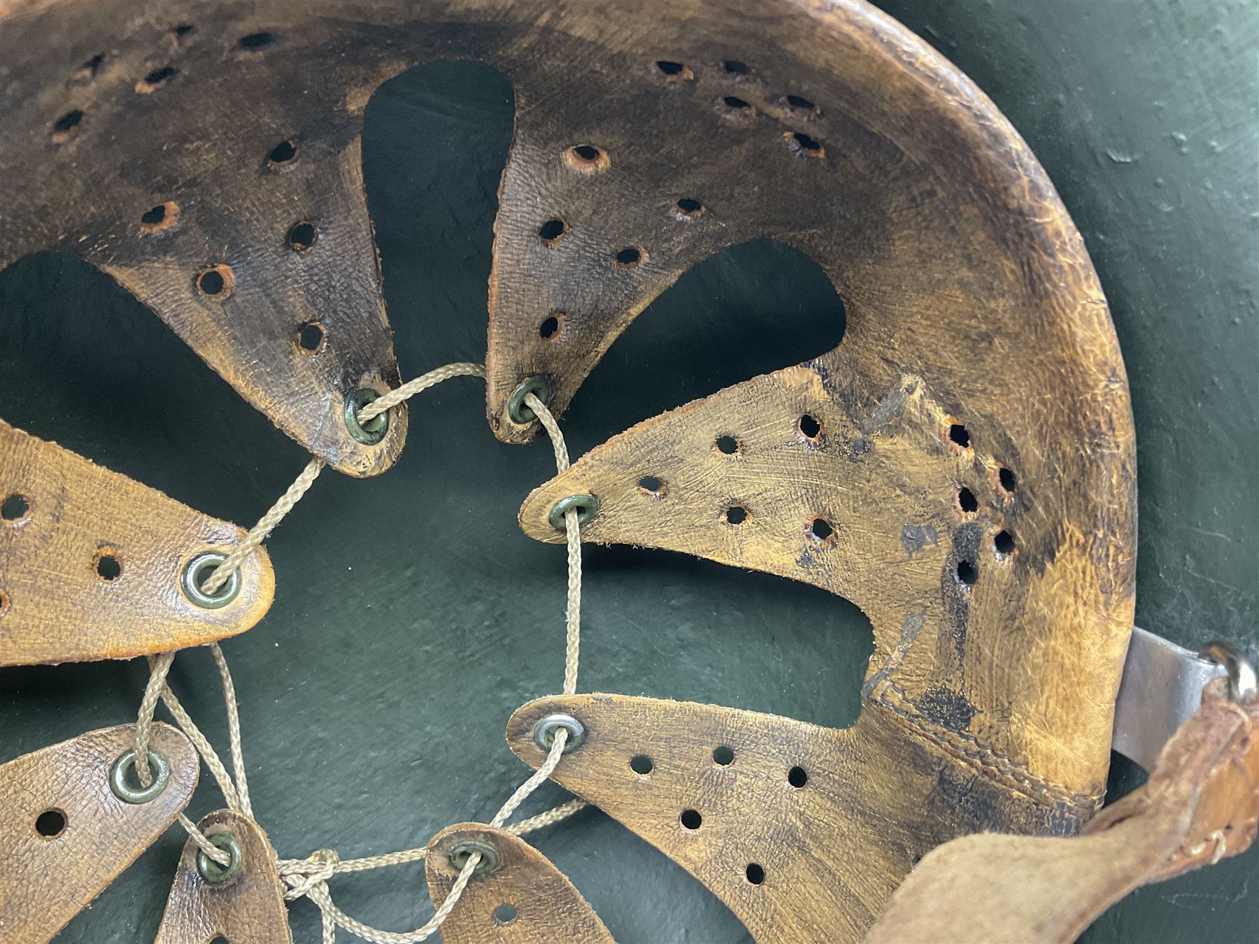 Fully restored German steel helmet, the camouflage painted exterior with two decals and replacement leather liner