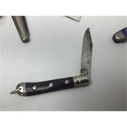 Seven pen knives, two lighters, including one Ronson example and a collection of postcards