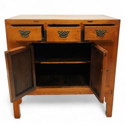 Mid-20th-century Chinese elm side cabinet, rectangular top above three drawers and a pair of panelled cupboard doors, mounted with traditional brass butterfly form handles and pierced circular lock plate 