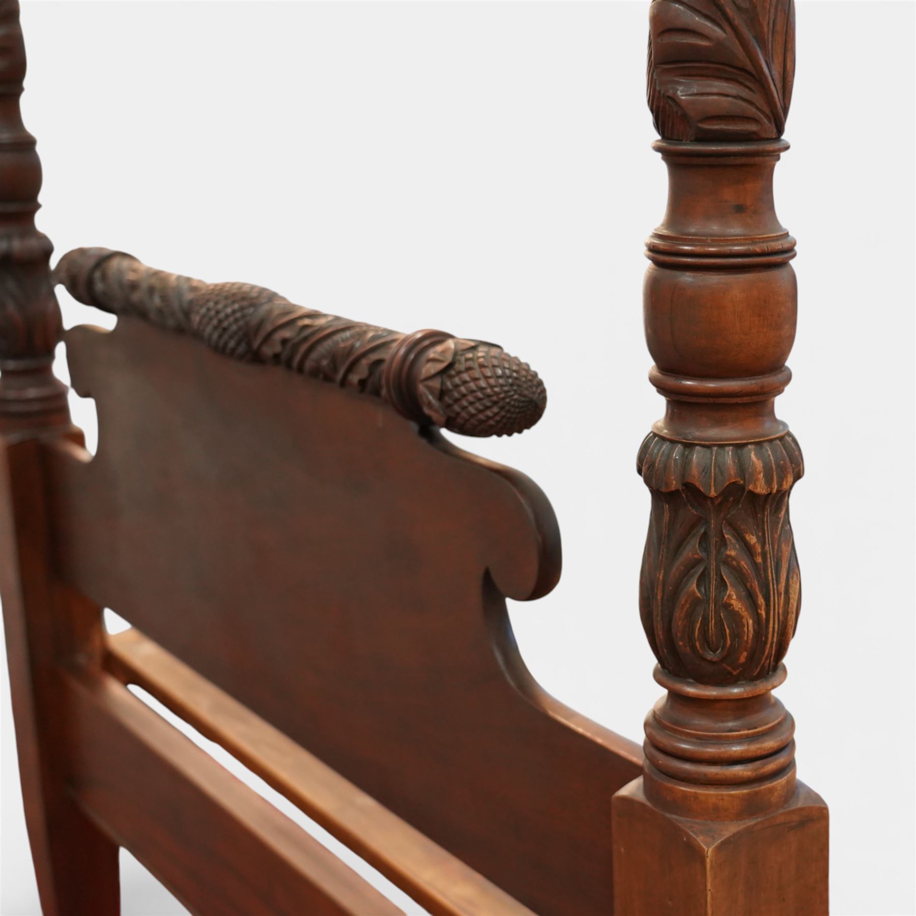 Early 19th century Regency carved mahogany four poster double bed, 4'6, the shaped headboard and footboard each surmounted by a finely carved pinecone and foliate moulded rail, flanked by ring turned and boldly spiral carved tapering posts with acorn finials, raised on square section legs, with slatted base