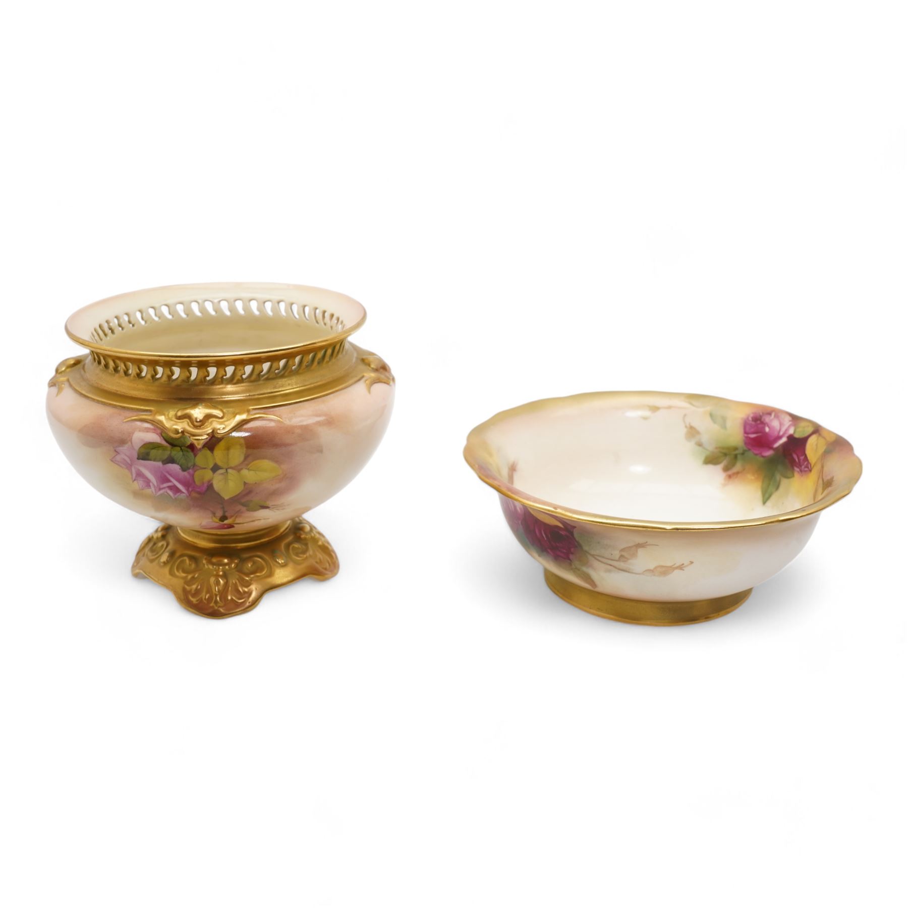 1920s Royal Worcester porcelain rose bowl, the flattened baluster body hand painted with roses and foliage, below a flared gilt pierced border, raised upon scroll moulded quatrefoil foot, shape no. H166, H13cm, together with a similarly decorated Royal Worcester bowl (2)