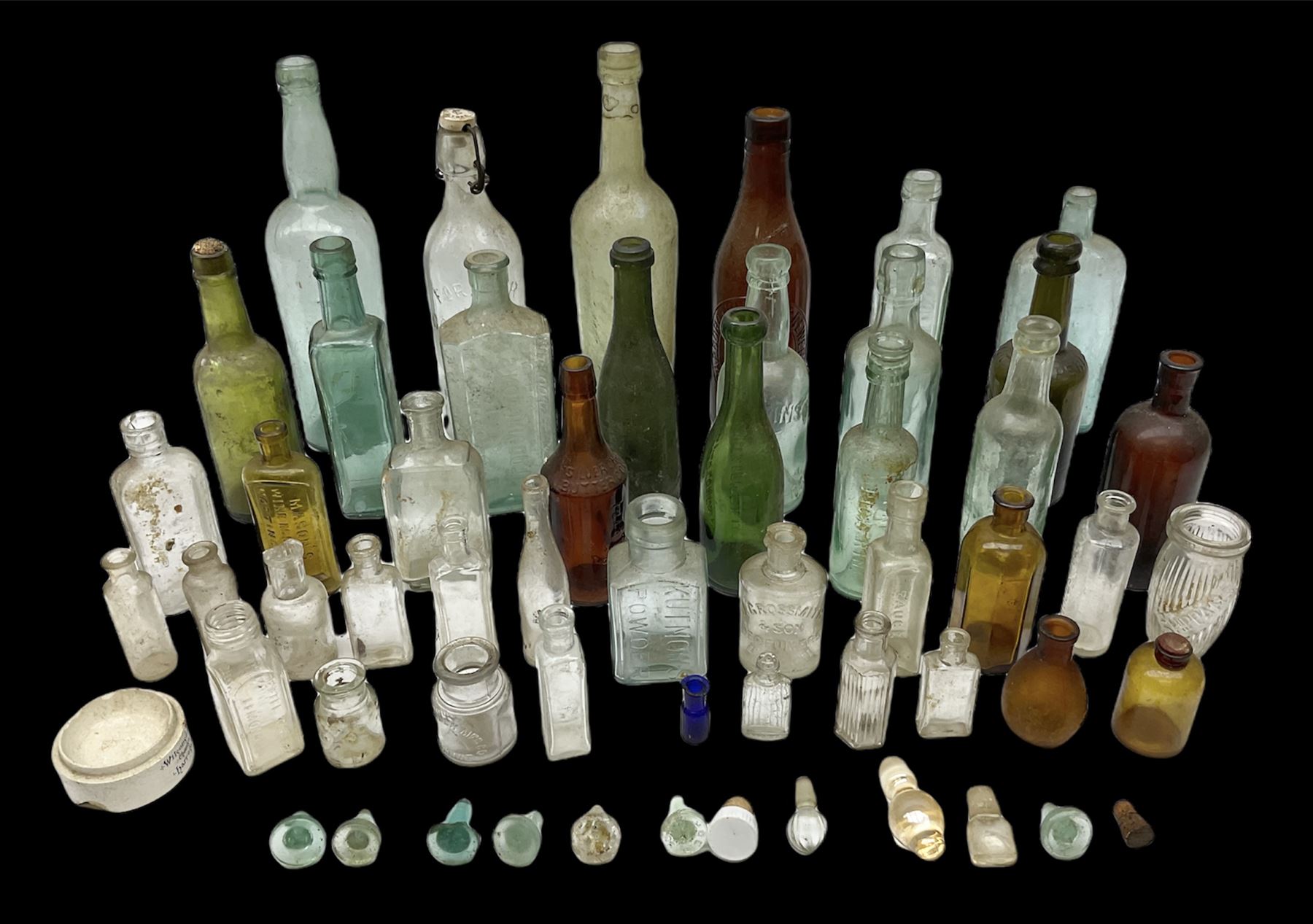 Collection of various vintage glass bottles and stoppers, including advertising bottles, sauce bottles and medical bottles etc