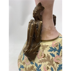A late 19th century Aesthetic Movement Old Hall vase designed by Christopher Dresser, the flared body decorated with stylised flowering vines, leading to a tapering neck and flared rim with twin figural handles (one s/d), and raised upon a circular footed base, with printed mark beneath, H35cm. 