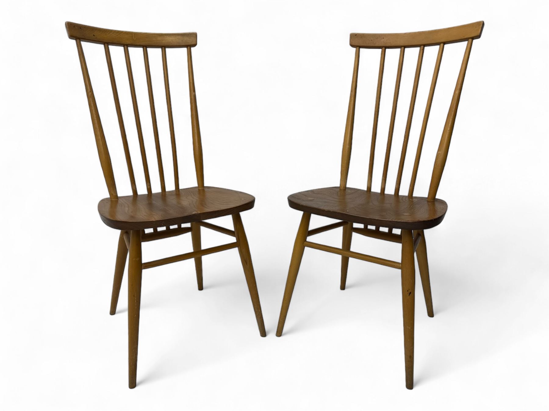 Ercol - pair of mid-20th century highback 'Windsor' chairs, curved top rail over six vertical spindles and shaped seat, on tapering cylindrical supports with stretchers