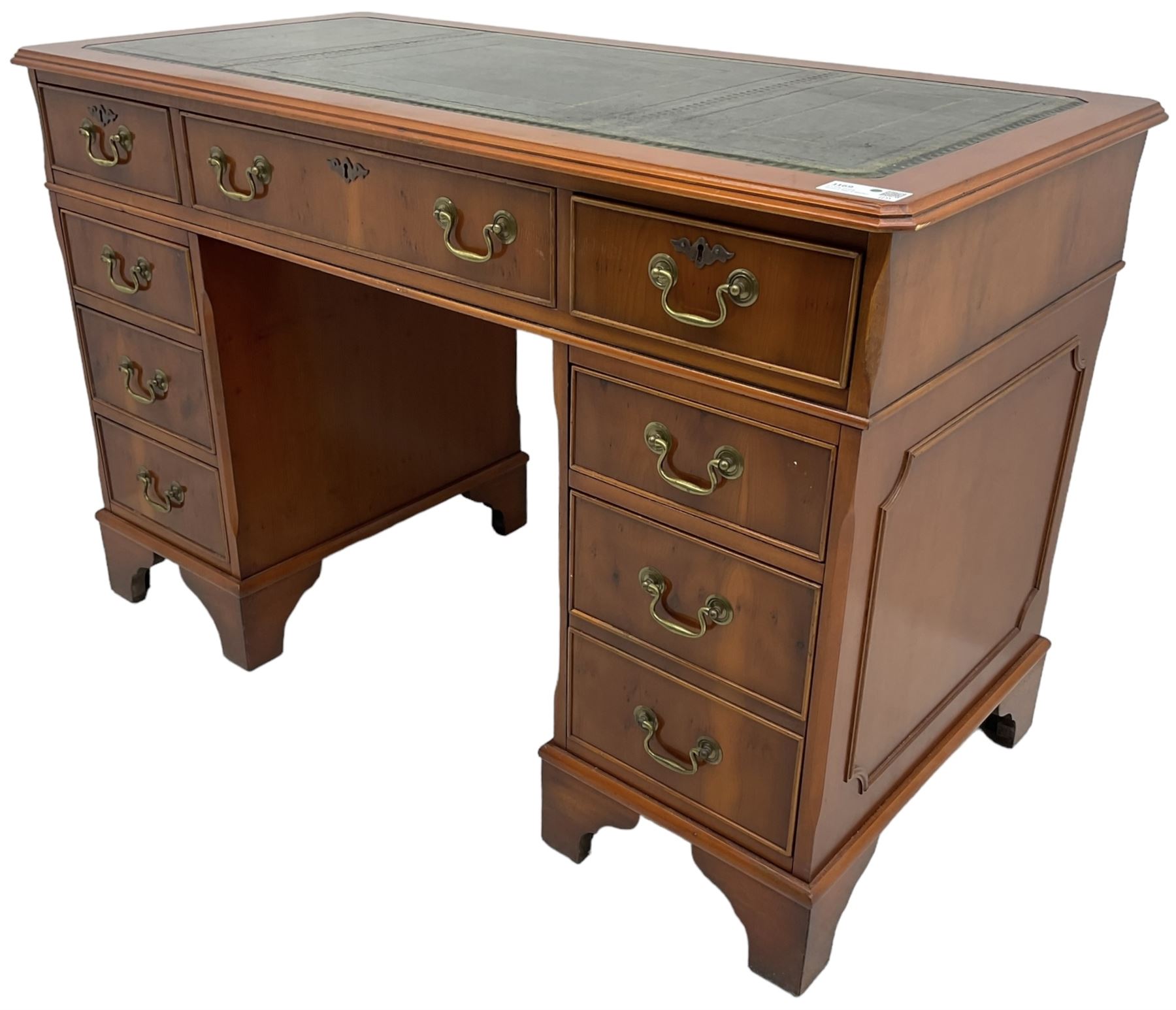 Georgian design yew wood twin pedestal desk, rectangular top with green leather inset writing surface, fitted with nine cock-beaded drawers, on bracket feet