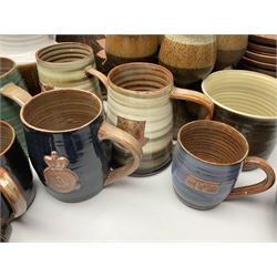 Wold studio pottery tankards, in various colours and relief decoration together with other studio items including vases, jugs and pots 