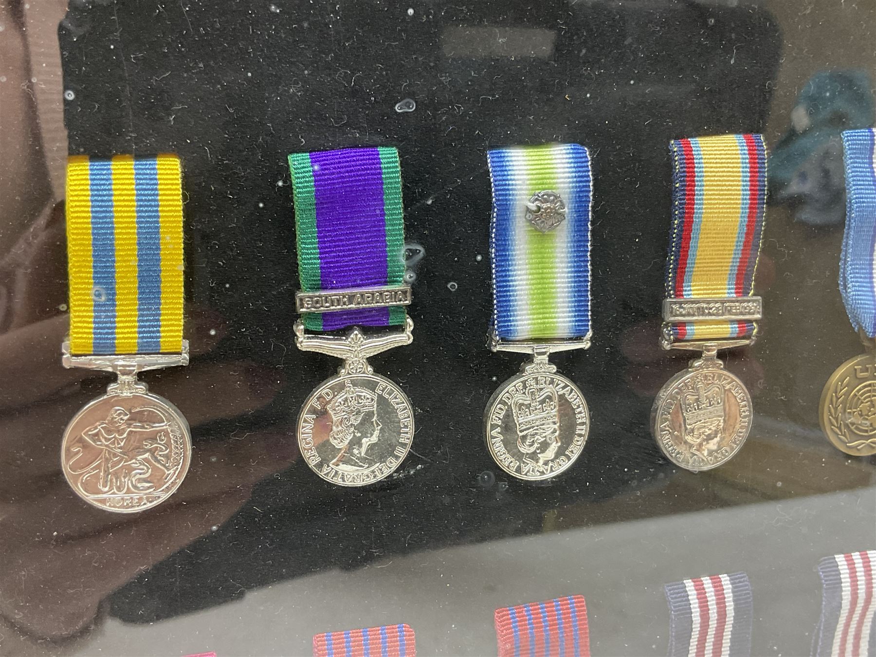 Limited edition large framed display board with sixty half-size copies of British Gallantry and Campaign Medals produced by Danbury Mint; all with ribbons and associated booklet