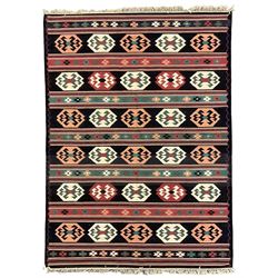 Turkish Kilim dark indigo ground rug, the field decorated with rows of geometric lozenges in alternating colours