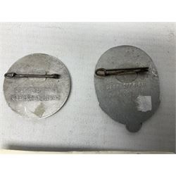 Two WW2 German 'tinnie' badges - Labour Day 1935 by Overhoff & Cie Ludenscheid & Labour Day 1936 by Ziemer & Sohne Oberstein/Nahe; together with pair of Afrika Korps tropical (pith) helmet metal decals (4)