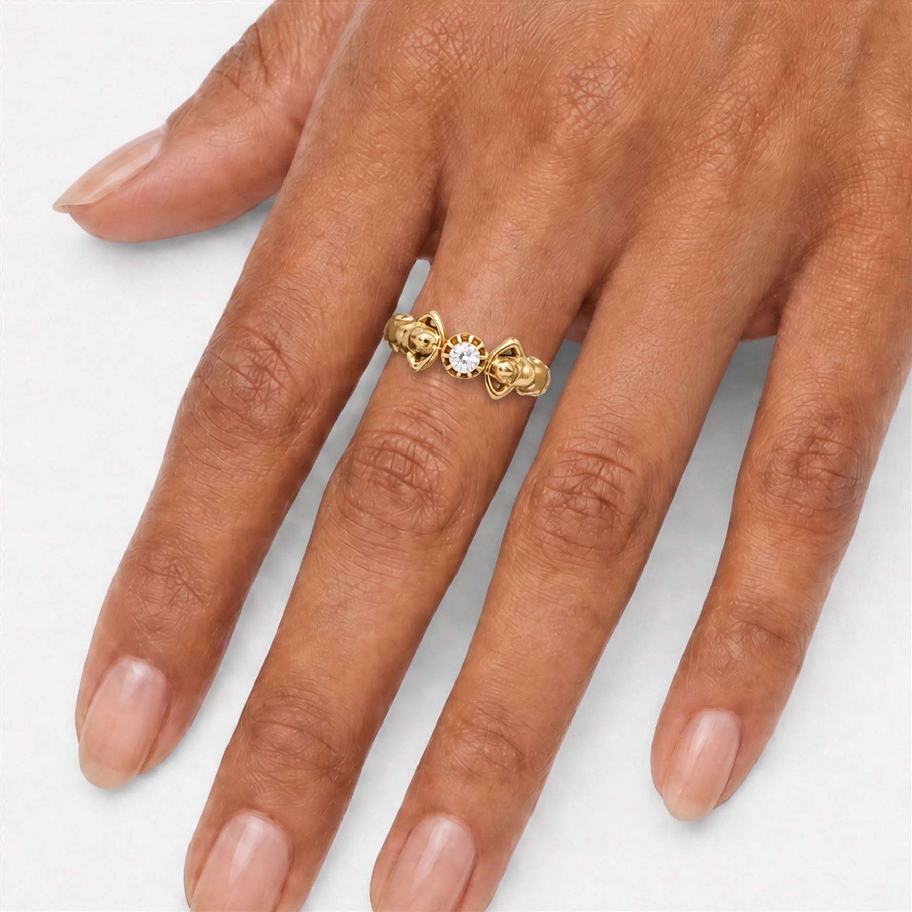 Gold diamond figural ring, single old cut diamond of approx 0.45 carat, with a nude female figure either side, stamped 18ct