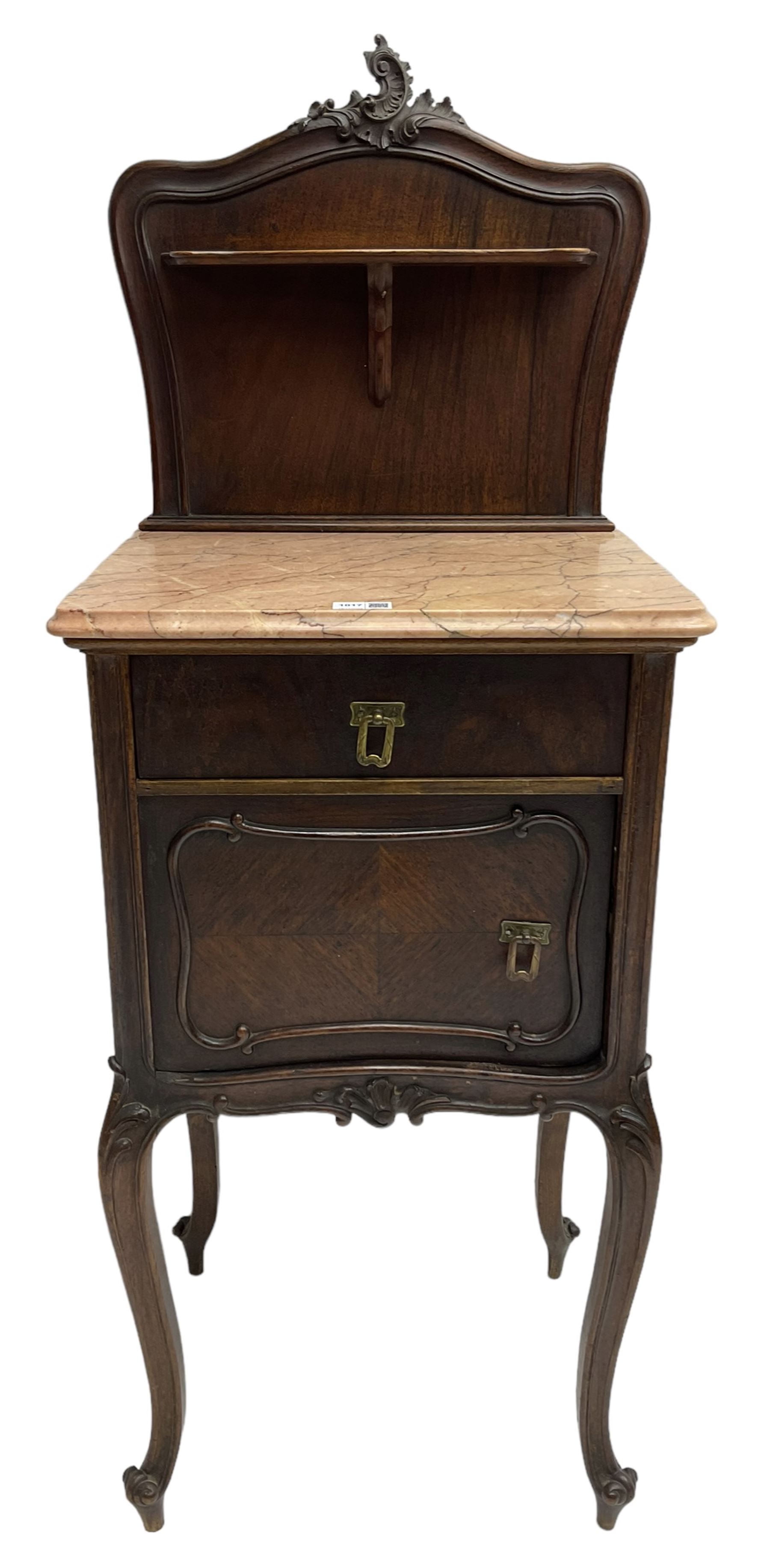 Late 19th to early 20th century walnut bedside pot cupboard, the shaped raised back with carved C-scroll pediment, pink variegated marble top, fitted with single drawer and cupboard, foliage carved cabriole supports with scroll carved terminals