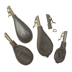 Four 19th century leather shot flasks and a spare brass fitting