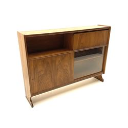 Nathan teak side cabinet, fitted with fall front cupboard, above two sliding doors one glazed, raised on stile supports 