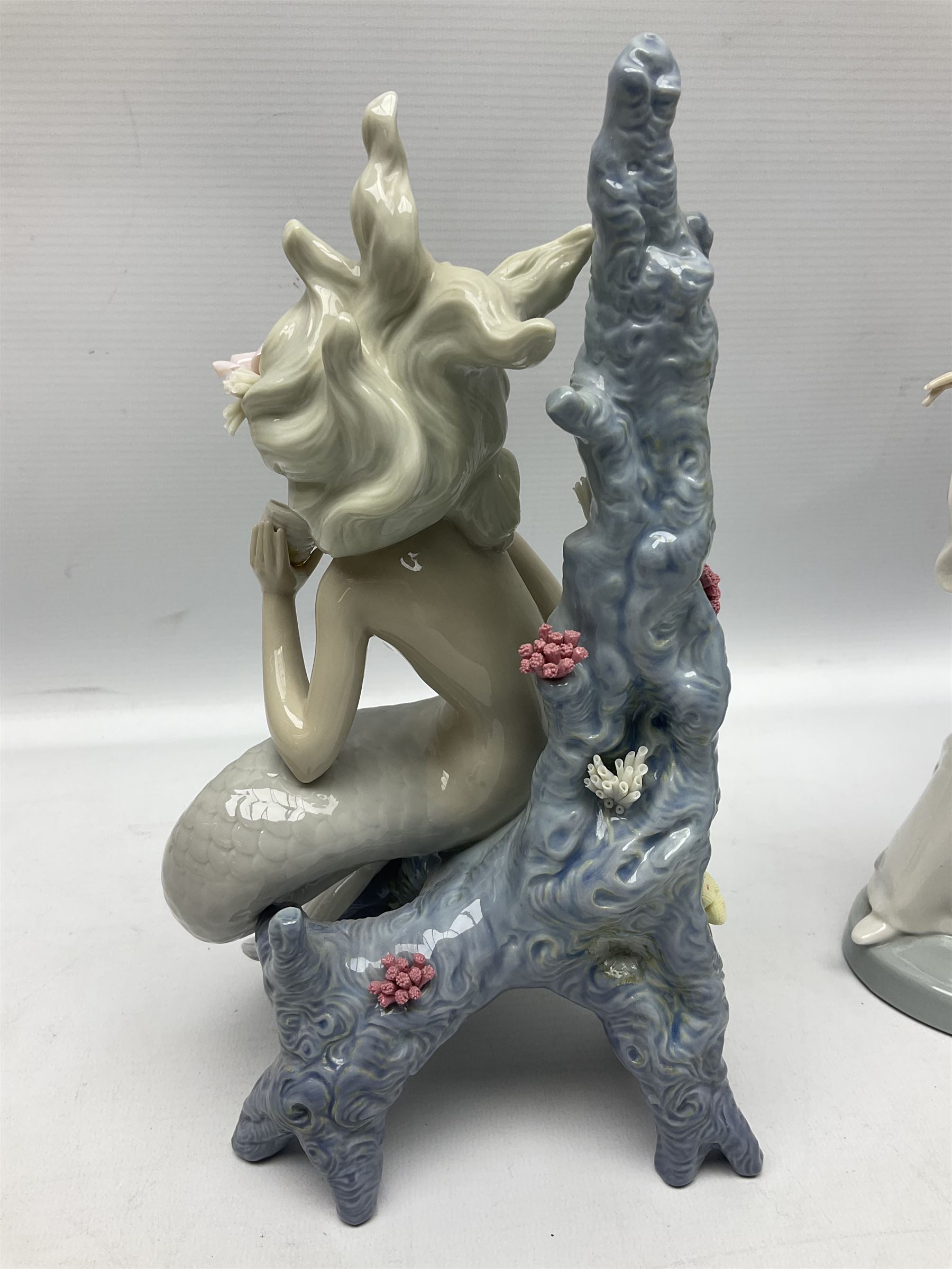 Four Lladro figures, comprising Touch of Class no 5377, Boy Student no 4517, Ocean Beauty no 5785 and Carnival Couple no 4882, largest example H45cm