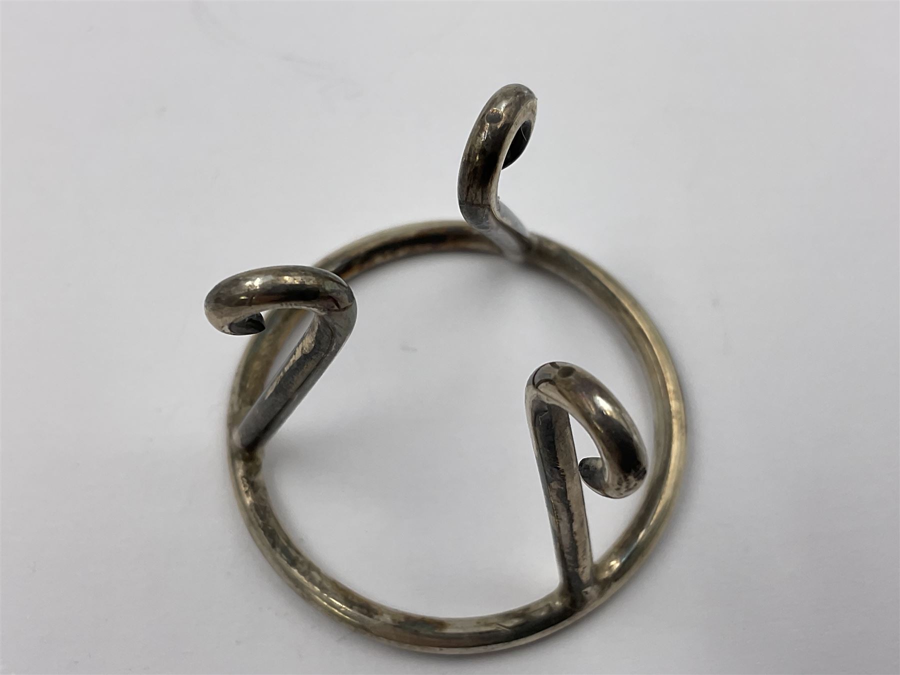 Modern silver limited edition Easter egg, no. 70/500, the gilt openwork body decorated with cascading bluebells and hinged cover with pierced circular panel set with a single faceted purple stone, opening to reveal a gilt interior, upon silver stand with three scrolling pad feet, each hallmarked St James House Company, London 1981, height including stand 8cm