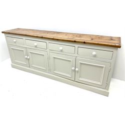 Large pine and painted side board, four drawers above four cupboards, plinth base