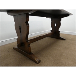  Titchmarsh and Goodwin oak refectory dining table, shaped and pierced solid end supports joined by single stretcher, sledge supports  