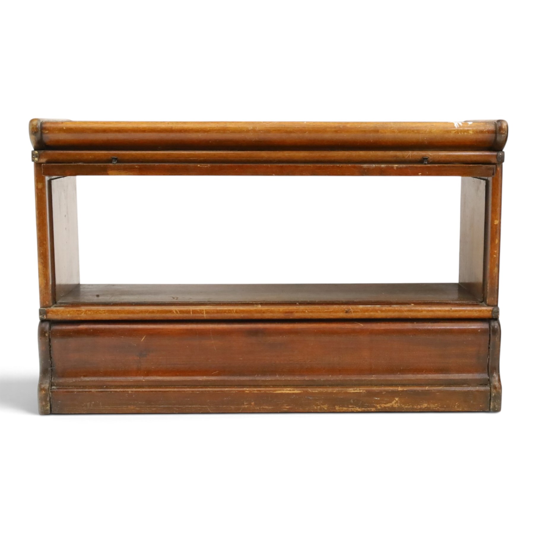 Globe Wernicke - early 20th century mahogany two-tier stacking library bookcase, fitted with glazed up-and-over doors, two drawers to the plinth base; together with a similar single-tier example (W87cm D27cm H54cm)
