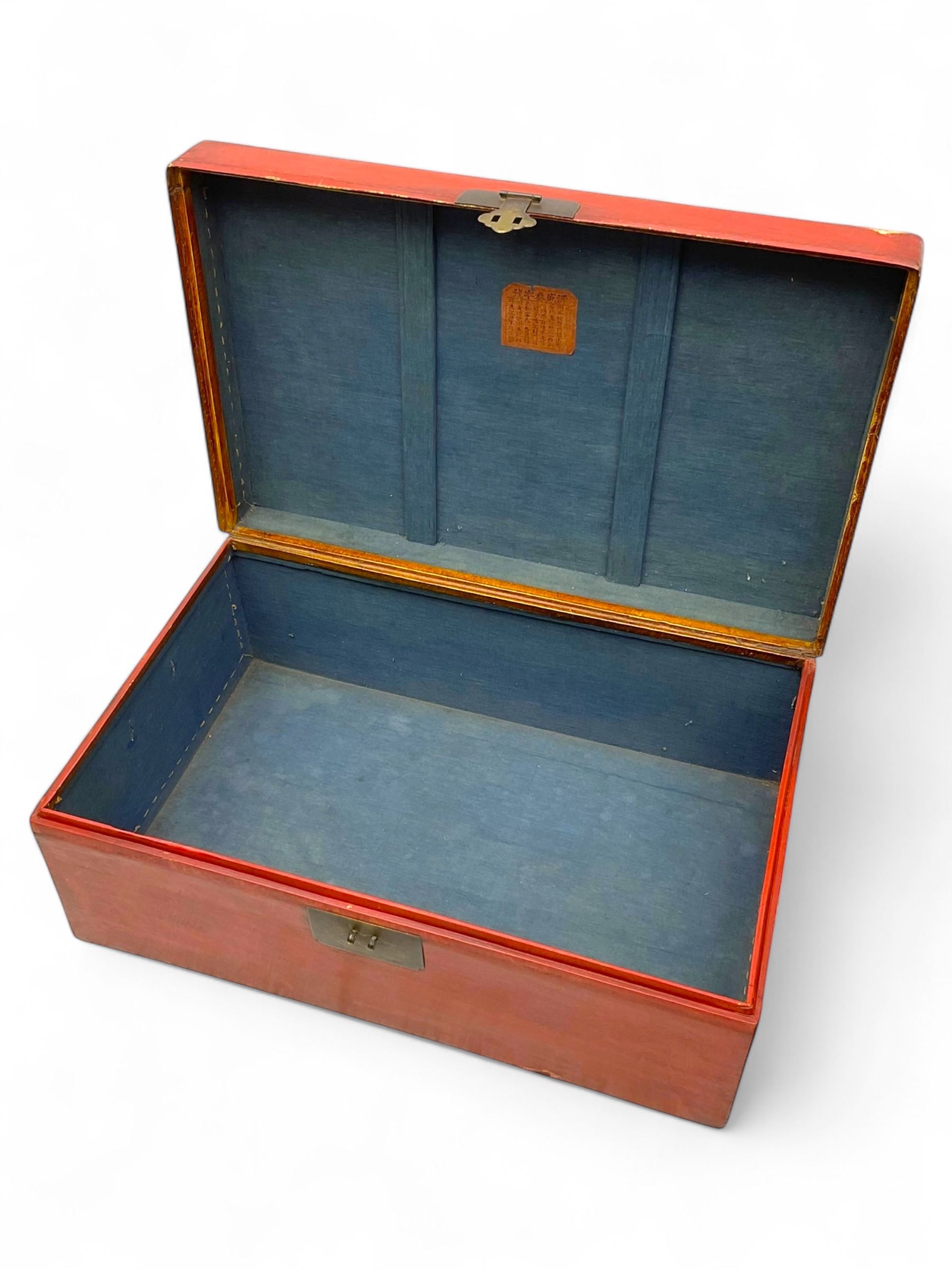 Pair of Chinese 18th century hand-painted leather-bound wooden trunks, each adorned with metal locks, twin carrying handles and patterned fabric-lined interior