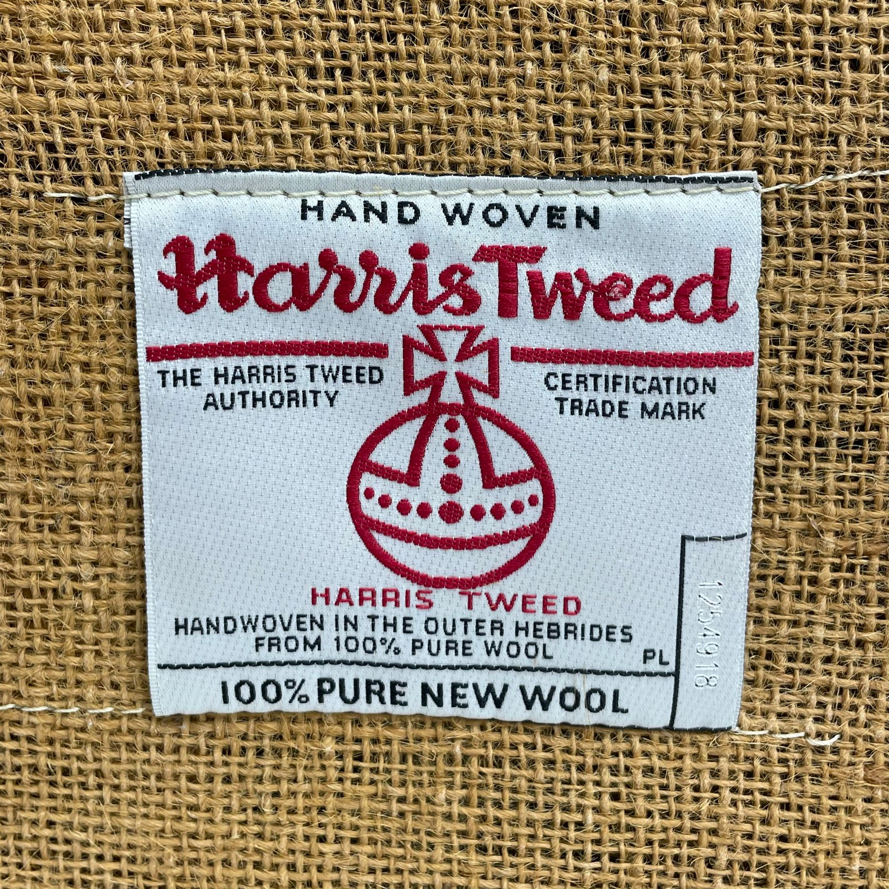 Interiors at Nine to Eleven - Edwardian design armchair, traditional shape with rolled arms, upholstered in 'Harris Tweed' fabric with leather piping, raised on square taping supports with castors