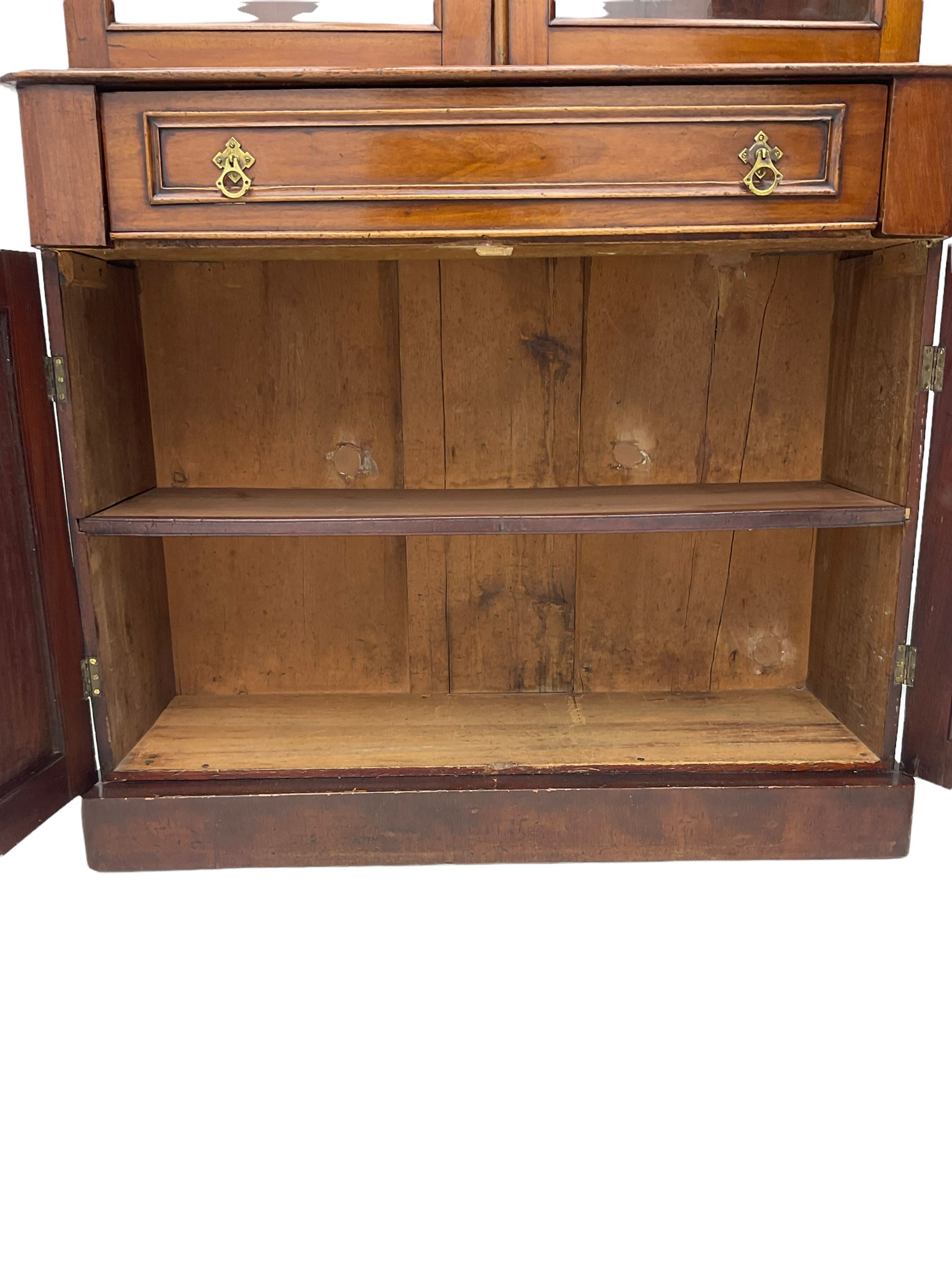 Victorian mahogany bookcase on cupboard, fitted with two glazed doors