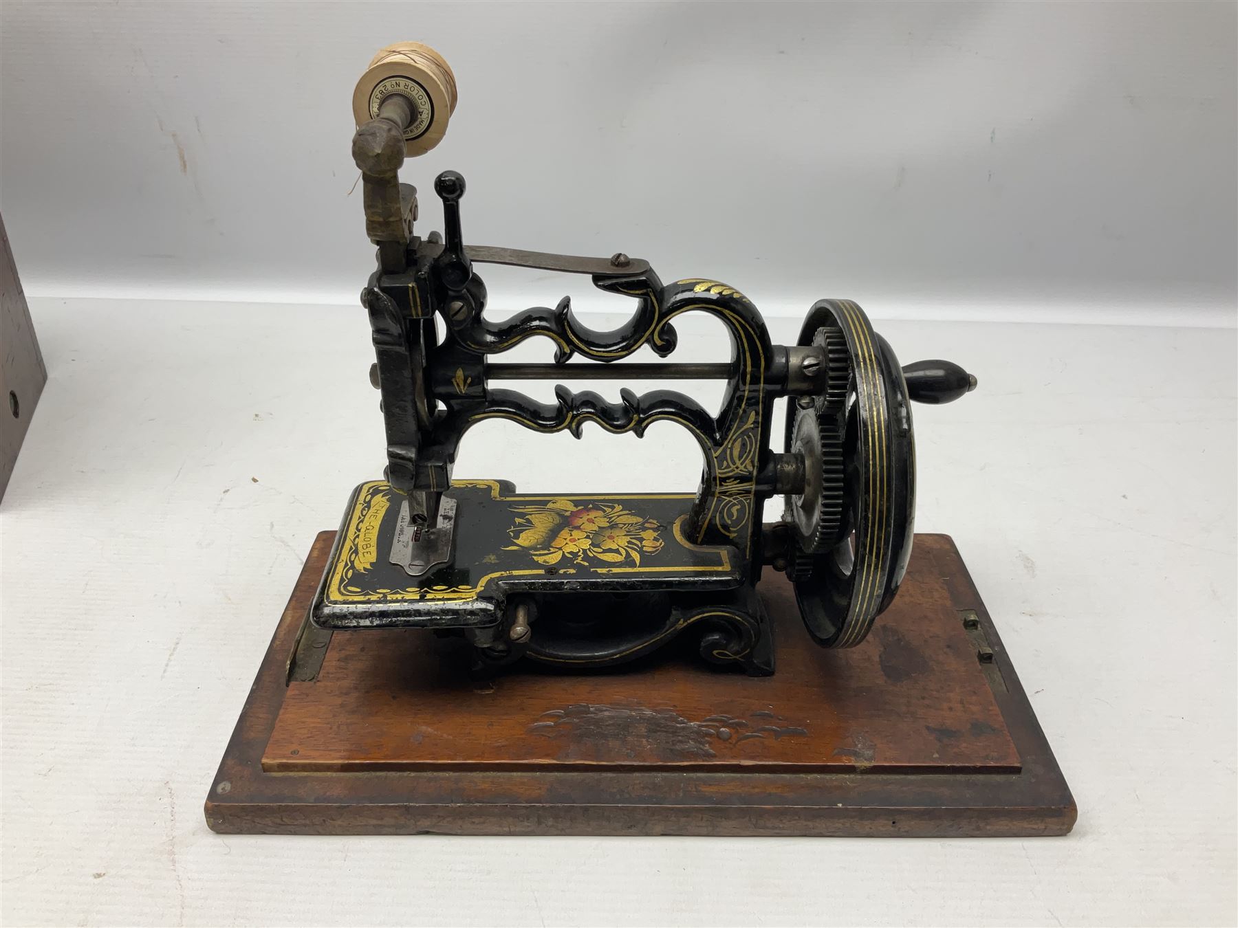 James G Weir 'The Globe' hand-cranked sewing machine, circa 1872, in black finish with gilt and flower painted decoration, the bed stamped Ja's G. Weir, 2 Carlisle Street, Soho Sq., London, with walnut locking carrying case and original manual, boxed H25cm 