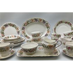 Paragon Country Lane pattern tea and dinner wares, comprising three dinner plates, six salad plates, nine side plates, three bowls, three smaller bowls, oval bowl, serving platter, sandwich plate, cake plate, seven teacups, two mugs, six saucers, twin handled sucrier and cover, open sucrier, and milk jug, together with Colclough teawares, including a cake stand. 