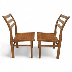 Treske of Thirsk - solid oak refectory dining suite, rectangular top with chamfered edge over trestle base united by a central stretcher, together with six matching slat back dining chairs, including two carvers, with panelled seats and square legs united by stretchers (H 87cm, W 62cm, D 57cm)
