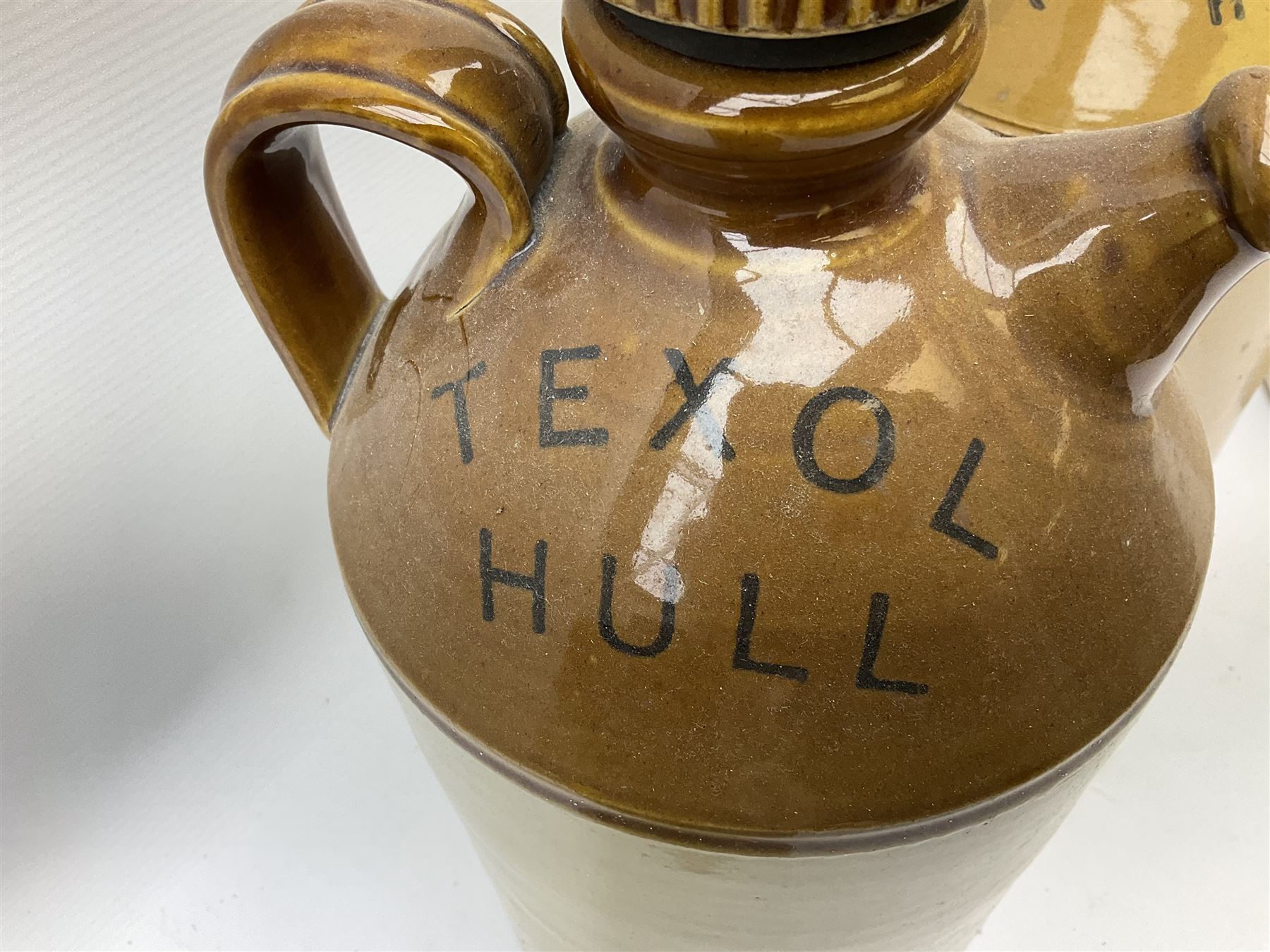 Four Hull stoneware flagons - Moors & Robsons Breweries Ltd H25cm, Hawkshaw Ltd Spencer Street Hull 1923, Triumph Herbal Brewery with brass dispensing tap and Texol Hull with screw stopper (4)  