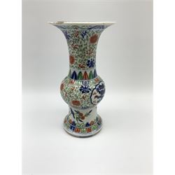 19th century Chinese vase, of gu form, decorated in the Wucai palette with two central panels containing five clawed dragons in blue and red, with foliate tendril surround, and lower border of birds upon blossoming branches, with six character underglaze blue Wanli mark within double concentric circle beneath, H23cm