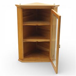 Unicornman - glazed oak corner cabinet, the triangular top with moulded cornice above a bevelled glass door, enclosing two fixed shelves, the canted front corner carved with Unicorn motif, by Geoff Gell of Coxwold