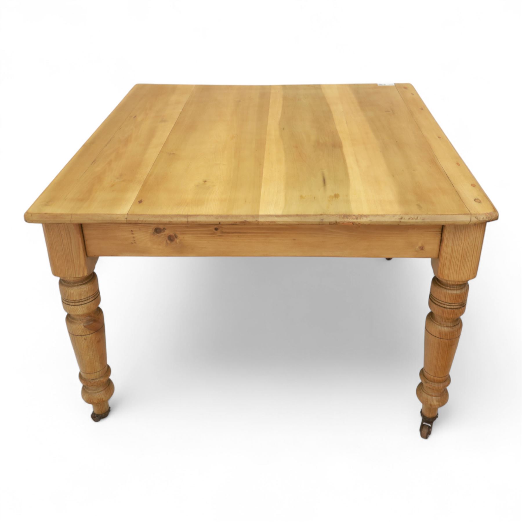 Contemporary pine kitchen table, rectangular top with moulded edge, fitted with single drawer, raised on turned supports with ceramic castors
